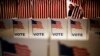 FILE - A voter fills out her ballot to vote in the Super Tuesday election at Sleepy Hollow Elementary School in Falls Church, Virginia.