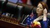 Australia's Prime Minister Julia Gillard adjusts her headphones at the start of a plenary session on the second day of the ASEM Summit in Vientiane, Laos, November 6, 2012. 
