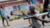 A demonstrator uses a slingshot during clashes with government security forces in Cibitoke, a district in Bujumbura, Burundi, May 29, 2015. 