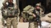 FILE - Afghan special forces arrive at the airport as they launch a counteroffensive to retake the city from Taliban insurgents, in Kunduz, Sept. 29, 2015. 