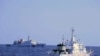 In this photo provided by the Philippine Coast Guard, a Chinese Coast Guard ship sails near a Philippine Coast Guard vessel during its patrol at Bajo de Masinloc, 124 nautical miles west of Zambales province, northwestern Philippines on March 2, 2022.