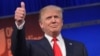 Real estate tycoon Donald Trump flashes the thumbs-up as he arrives on stage for the start of the prime time Republican presidential debate on Aug. 6, 2015 at the Quicken Loans Arena in Cleveland, Ohio.