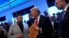 Republican presidential nominee former President Donald Trump talks with owner Albert Abbas as he visits The Great Commoner, Nov. 1, 2024, in Dearborn, Michigan, as Massad Boulos watches at right.