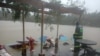 A person looks at flood waters following a hit of the tropical cyclone Kompasu in Baguio, Philippines, October 12, 2021.