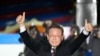FILE - Lee Jae-myung, the presidential candidate of the ruling Democratic Party, raises his hands during a presidential election campaign in Seoul, South Korea, March 8, 2022. 