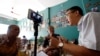 In this photo taken in May 15, 2018, rights activist Le Van Dung (R) live streams on Facebook in a coffee shop in Hanoi, Vietnam. REUTERS/Kham