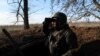 A member of the 68th Independent Jager Brigade of the Ukrainian Army scans the horizon for Russian military from his position in the trenches near the frontline in the Southern Donbas region in Ukraine, Nov. 29, 2022.REuters/Leah Millis