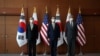 Kim Gunn, South Korea's new special representative for Korean Peninsula peace and security affairs, his U.S. counterpart Sung Kim and Japanese counterpart Takehiro Funakoshi pose for photographs before their meeting at the Foreign Ministry in Seoul, South Korea, June 3, 2022. 