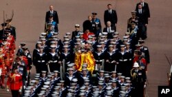 Queen Elizabeth II's funeral cortege borne on the State Gun Carriage of the Royal Navy travels along The Mall in London, Monday, Sept. 19, 2022. (Chip Somodevilla/Pool Photo via AP)