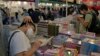 Visitors read at a booth during the annual book fair in Hong Kong, July 20, 2022. 