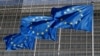 FILE - European Union flags flutter outside the EU Commission headquarters in Brussels, Belgium, June 17, 2022.
