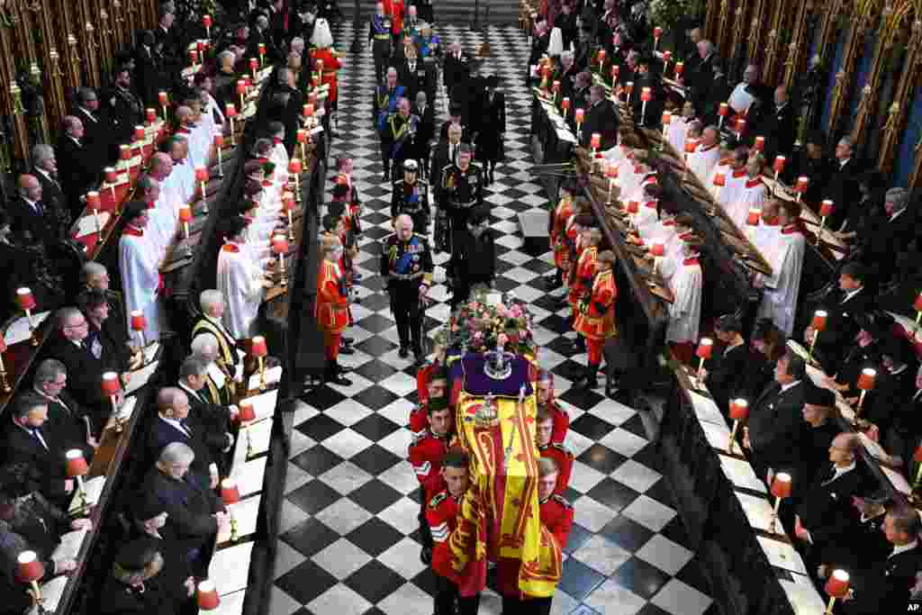 Britain&#39;s King Charles III, left, Camilla, Queen Consort, Princess Anne, Vice Admiral Timothy Laurence, Prince Andrew, Prince Edward, Sophie, Countess of Wessex, Prince William, Prince George Catherine, Princess of Wales, Prince Harry and Meghan, Duchess of Sussex walk behind the coffin of Queen Elizabeth as they leave Westminster Abbey in central London, Sept. 19, 2022.&nbsp;