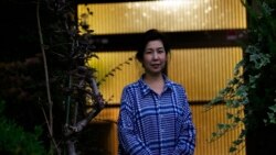 Kaori Takada poses for a photo at her home in Matsubara, south of Osaka, western Japan, Nov. 16, 2021.