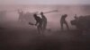 Syrian army personnel load howitzers near the village of Morek, Syria, Oct. 7, 2015.