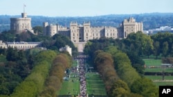People make their way along the Long Walk towards Cambridge gate outside Windsor Castle to lay flowers for the late Queen Elizabeth II in Windsor, England, Sept. 18, 2022.