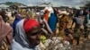 FILE - Somali refugees organize their collected ration of food during a distribution exercise outside a United Nations World Food Program center at a refugee settlement in Dadaab, Kenya, October 2013.