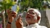 FILE - Hindu nationalist Narendra Modi, the prime ministerial candidate for India's main opposition Bharatiya Janata Party (BJP), takes a "selfie" with a mobile phone after casting his vote at a polling station during the seventh phase of India's general 