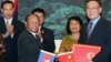 Wu Bangguo, chairman of the Standing Committee of the National People's Congress (NPC) of China, second right, and Heng Samrin, president of the Cambodian National Assembly shake hands after exchanging documents on cooperation between NPC and the Cambodia.