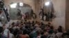 FILE - Suspected Islamic State members sit inside a small room in a prison south of Mosul, July 18, 2017. 