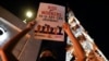 An activist holds a slogan outside the headquarters of broadcast network ABS-CBN corp. on Tuesday, May 5, 2020 in Quezon city, Metro Manila, Philippines. A Philippine government agency has ordered the country's leading broadcast network, which the…