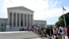 FILE - People wait in line to go into the Supreme Court in Washington.