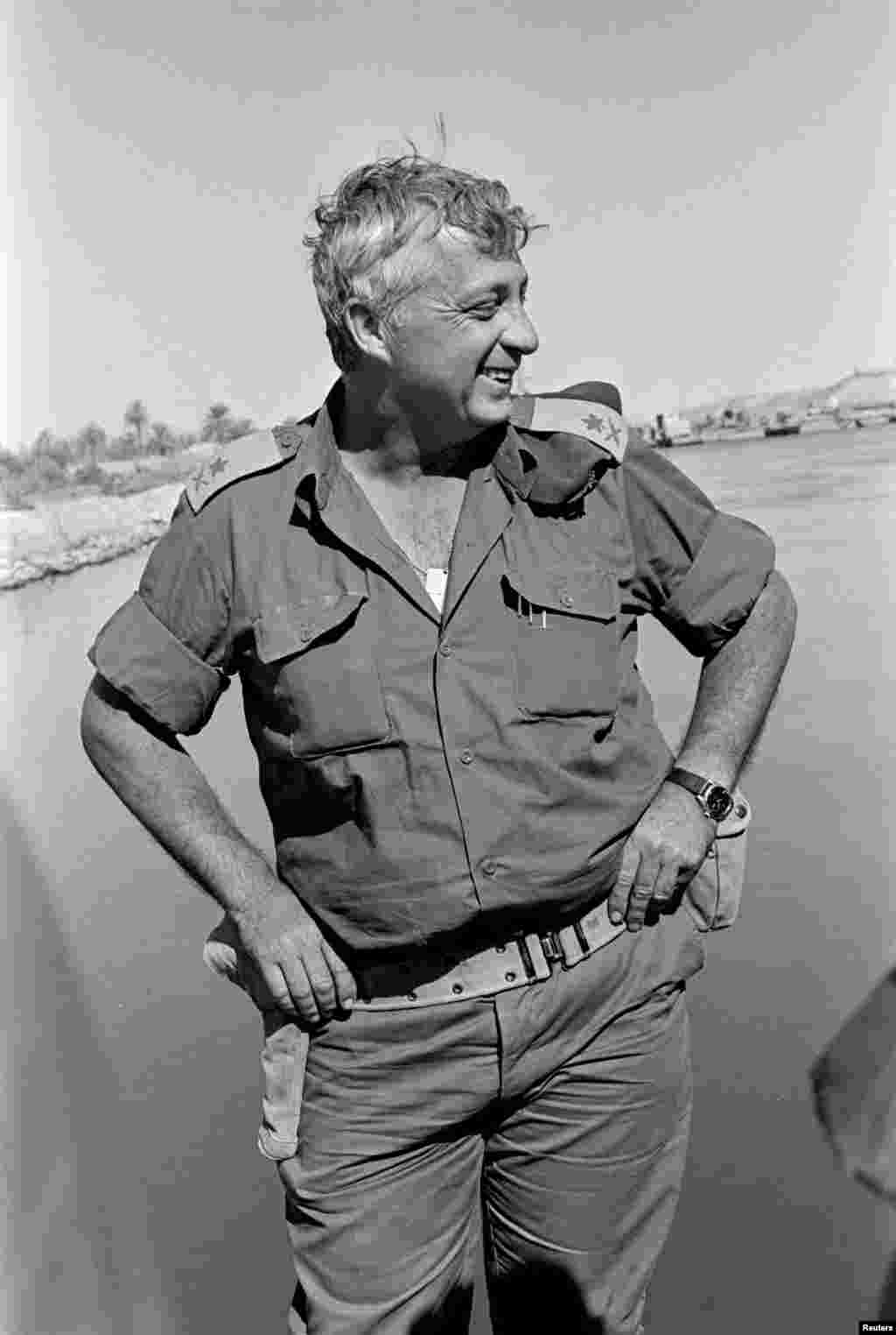 Israeli Major General in the Reserves Ariel Sharon smiles near the Suez Canal, then occupied by Israel, Oct. 31, 1973.