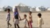 Children walk at a camp for people recently displaced by fighting in Yemen's northern province of al-Jawf between government forces and Houthis, in Marib, Yemen, March 8, 2020.