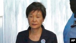 FILE - Former South Korean President Park Geun-hye arrives to attend a hearing on the extension of her detention at the Seoul Central District Court in Seoul, South Korea on Oct. 10, 2017.