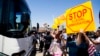 FILE - Demonstrators rally against the arrival of undocumented migrants who were scheduled to be processed at the Murrieta Border Patrol Station in Murrieta, California, July 1, 2014.