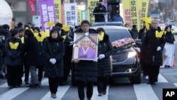 FILE - Activist Yoon Meehyang, center left, marches toward the Japanese Embassy during a funeral ceremony of Kim Bok-dong, a former South Korean sex slave, in Seoul, South Korea, on Feb. 1, 2019. 