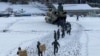 In this photo provided by Japanese Ministry of Defense, members of Japan Self-Defense Forces carry relief goods in the earthquake-hit city Wajima, Ishikawa prefecture, Japan, Jan. 8, 2024.