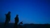FILE - Russia-backed rebels are seen guarding territory after sunset near Donetsk, eastern Ukraine, Aug. 2, 2015.