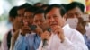 FILE: Cambodian Vice President of the National Assembly Kem Sokha, also vice president of Cambodia National Rescue Party, foreground, delivers a speech during a Buddhist ceremony to mark 18th anniversary in Phnom Penh, Cambodia, Monday, March 30, 2015.