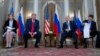 Russian President Vladimir Putin, right, and U.S. President Donald Trump, left, with their interpreters at the beginning of their meeting at the Presidential Palace in Helsinki, Finland, July 16, 2018.