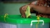 FILE - A voter cast her ballot for the by-election in Yangon, Myanmar, Nov. 3, 2018. 