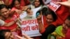 FILE - Activists of India’s opposition Congress party beat a placard with portrait of Prime Minster Narendra Modi during a protest in Mumbai, India, Aug. 5, 2015. 