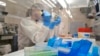 In this April 12, 2018 photo lab technician extracts DNA for whole genome sequencing at the Colorado Department of Public Health & Environment’s Molecular Science Laboratory in Denver. Some experts say the new DNA testing is revolutionizing the way disease detectives to identify and solve food poisoning outbreaks. (AP Photo/P. Solomon Banda)