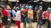 Garment workers leave the Propitious (Cambodia) Garment Ltd. factory for a lunch break in Kandal province, Cambodia, March 20, 2020. (Kann Vicheika/VOA Khmer)