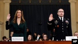 Jennifer Williams, an aide to Vice President Mike Pence, left, and National Security Council aide Lt. Col. Alexander Vindman, are sworn in to testify before the House Intelligence Committee on Capitol Hill in Washington, Nov. 19, 2019, during a public imp