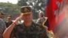 FILE PHOTO - Lt. Gen. Hun Manet, son of Cambodian Prime Minister Hun Sen and deputy commander of the Royal Cambodian Army and commander of the National Counter Terror Special Force, walks through honorary guards as his arrives for presiding over a U.S.-backed peacekeeping exercise dubbed "Angkor Sentinel 2014" at the Cambodian tank command headquarters in Kampong Speu province, 60 kilometers (37 miles) west of Phnom Penh, Cambodia, Monday, April 21, 2014. (AP Photo/Heng Sinith)