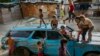 Children play on top of an abandoned car at the "Aguerridos Liberator" shanty town in Caracas, Venezuela, May 9, 2019. 