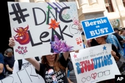 FILE - Demonstrators make their way around downtown, Monday, July 25, 2016, in Philadelphia, during the first day of the Democratic National Convention after some of the 19,000 emails, presumably stolen from the DNC by hackers, were posted to the website WikiLeaks.