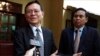 FILE PHOTO - Cambodia's opposition leader Kem Sokha, left, talks to the media at his home before leaving for the court hearing in Phnom Penh, Thursday, Jan. 16, 2020.
