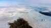 This 2016 photo provided by NASA shows patches of bare land at the Jakobshavn glacier in Greenland. The major Greenland glacier that was one of the fastest shrinking ice and snow masses on Earth is growing again, a new NASA study finds. (NASA via AP)