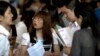 FILE - Chinese job seekers visit a job fair held at the China International Exhibition Center in Beijing.