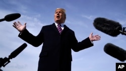 President Donald Trump talks to the media before he boards Air Force One for a trip to Los Angeles to attend a campaign fundraiser, Feb. 18, 2020, at Andrews Air Force Base, Maryland. 