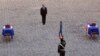 French President Francois Hollande pays his respects in front of the two flag-draped coffins bearing the French soldiers who died last week in the Central African Republic, during a ceremony at the Invalides, in Paris, Dec. 16, 2013. 