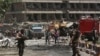 FILE - Security forces inspect the site of a massive suicide attack that killed more than 150, according to the Afghan president, in front of the German Embassy in Kabul, Afghanistan, May 31,2017. A letter by a senior Islamic State militant points to a growing power struggle within the group’s Afghan affiliate, pitting Uzbek fighters against Pakistanis.