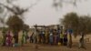 FILE - Women crowd a well in the village of Kiral, near Goudoude Diobe in the Matam region of northeastern Senegal.
