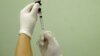 FILE - A health agent prepares a vaccine in Rio de Janeiro. Researchers in Brazil developed a vaccine to fight addiction to cocaine. 